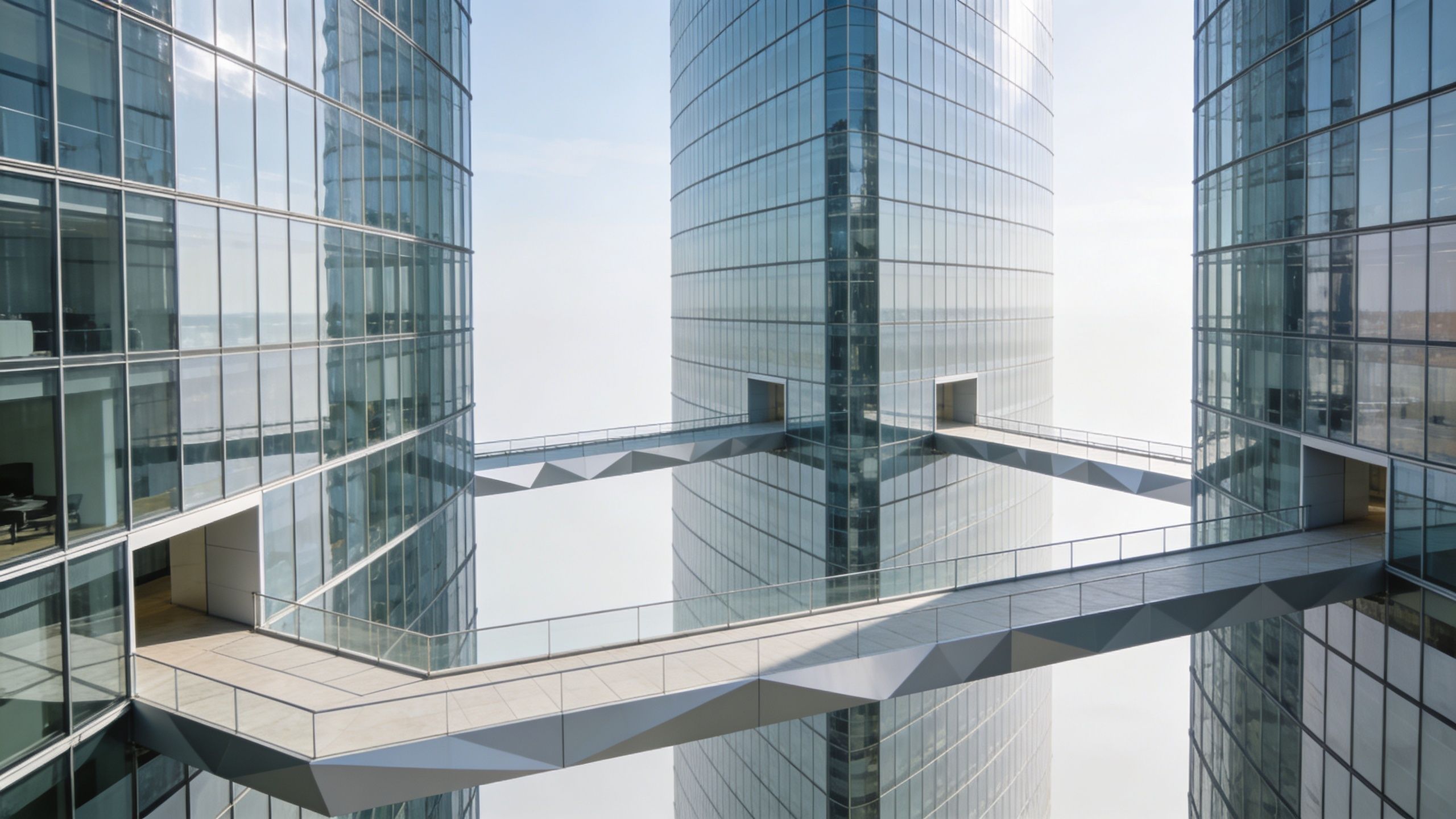 A modern glass skyscraper with connecting skybridges suspended above a sea of thick white clouds.