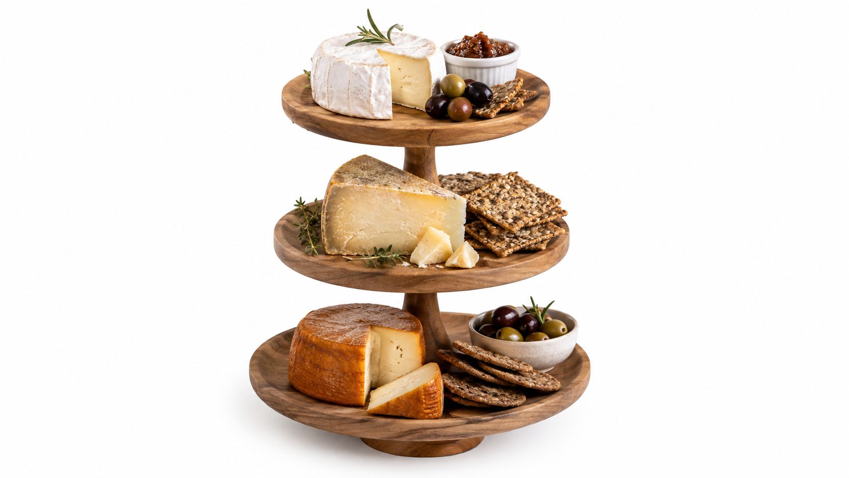 A three-tiered wooden serving platter displaying various cheeses, crackers, olives, and a bowl of chutney.