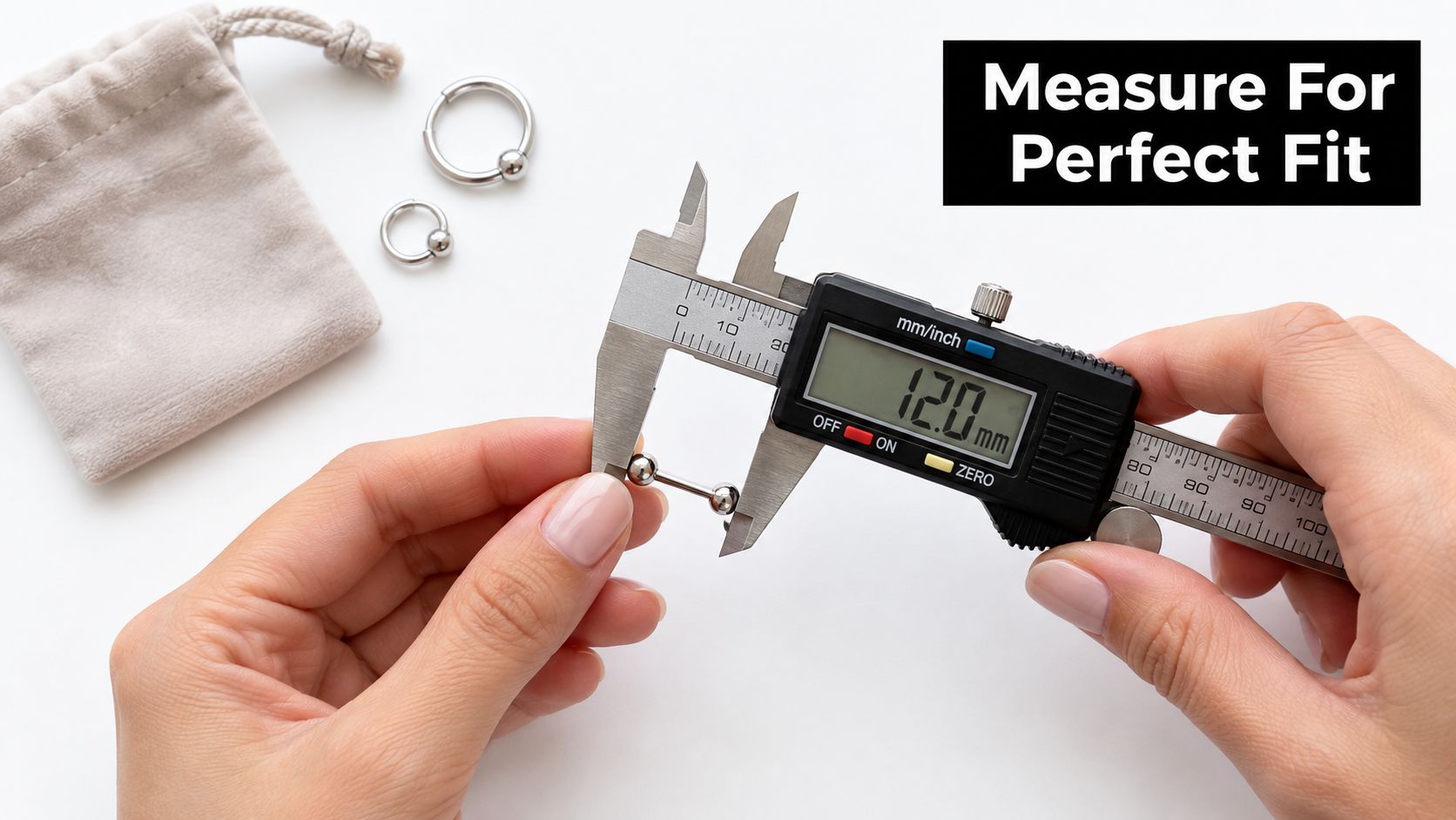 A pair of hands using a digital caliper to measure the length of a body jewelry barbell.