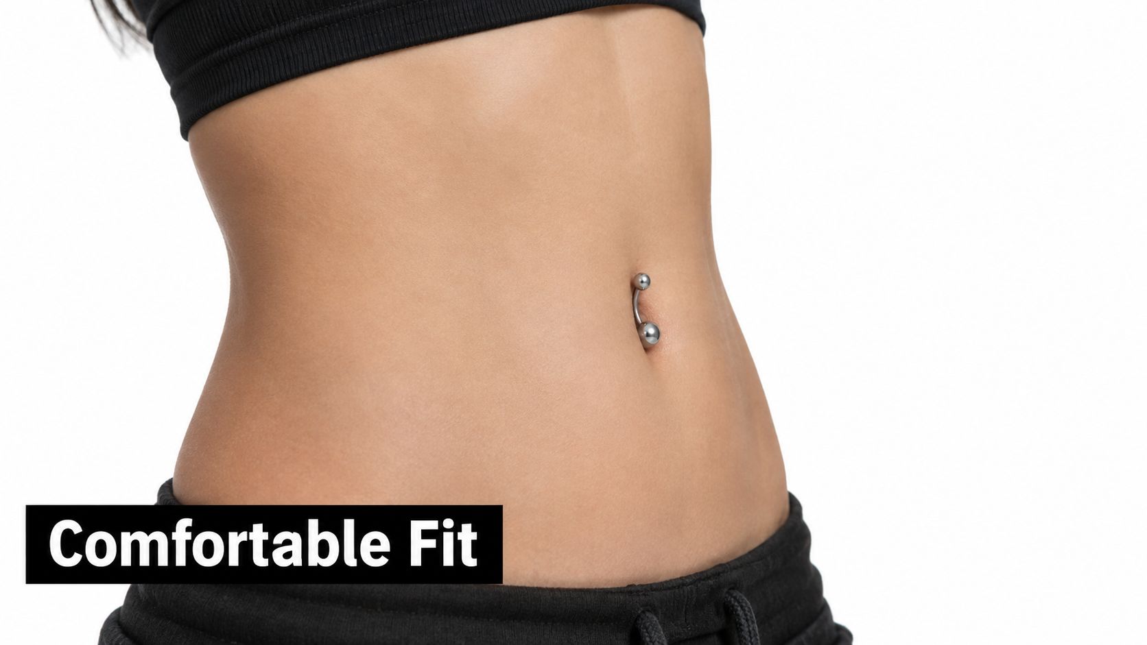 A close-up view of a woman's toned abdomen featuring a metallic belly button piercing and comfortable clothing.