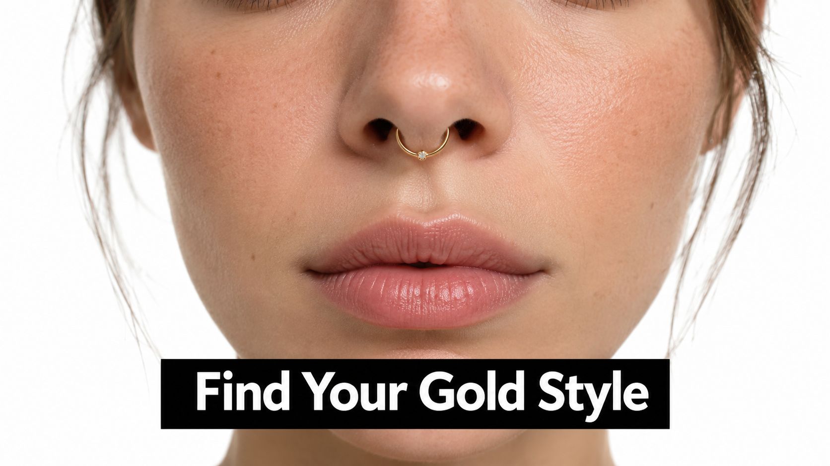 A close-up view of a woman wearing a delicate gold septum piercing ring with a single diamond.