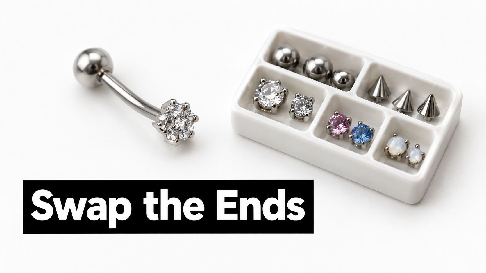 A curved barbell jewelry piece next to a white tray containing various interchangeable piercing bead ends.