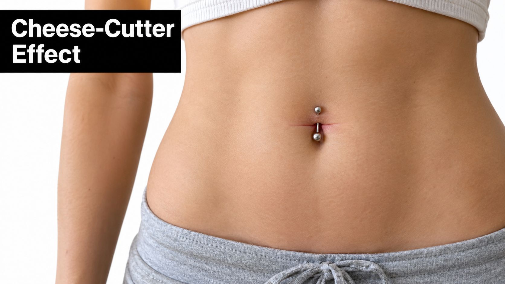 A close-up view of a person's midriff showcasing a silver navel piercing in the belly button.