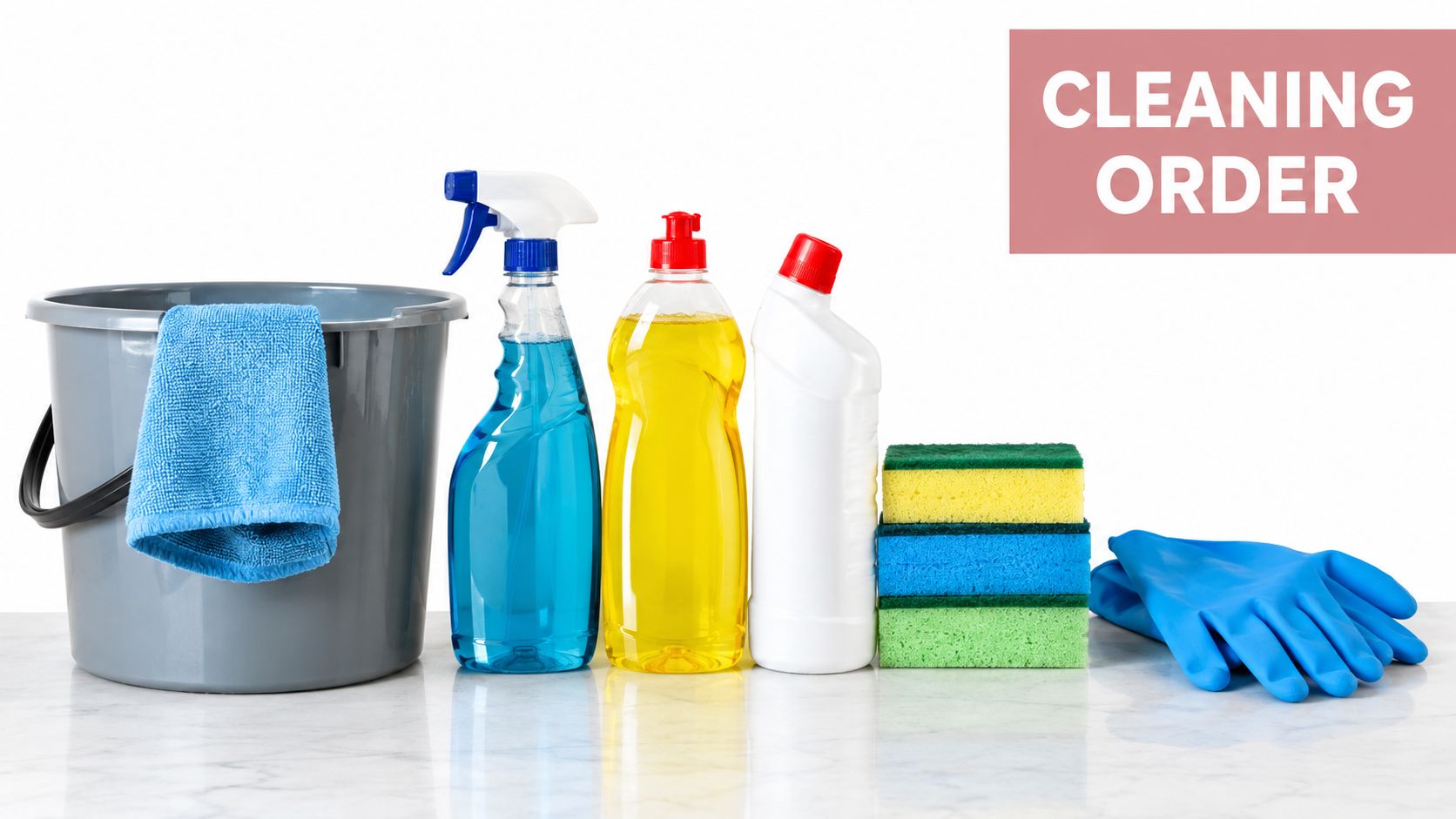 Cleaning supplies including a bucket, blue cloth, spray bottles, sponges, and rubber gloves on a marble surface.