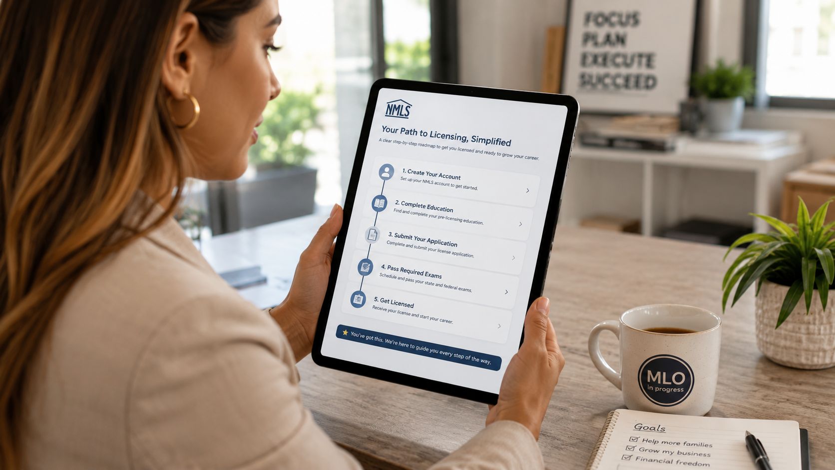 A professional woman reviews a NMLS licensing roadmap on her digital tablet while working at her desk.