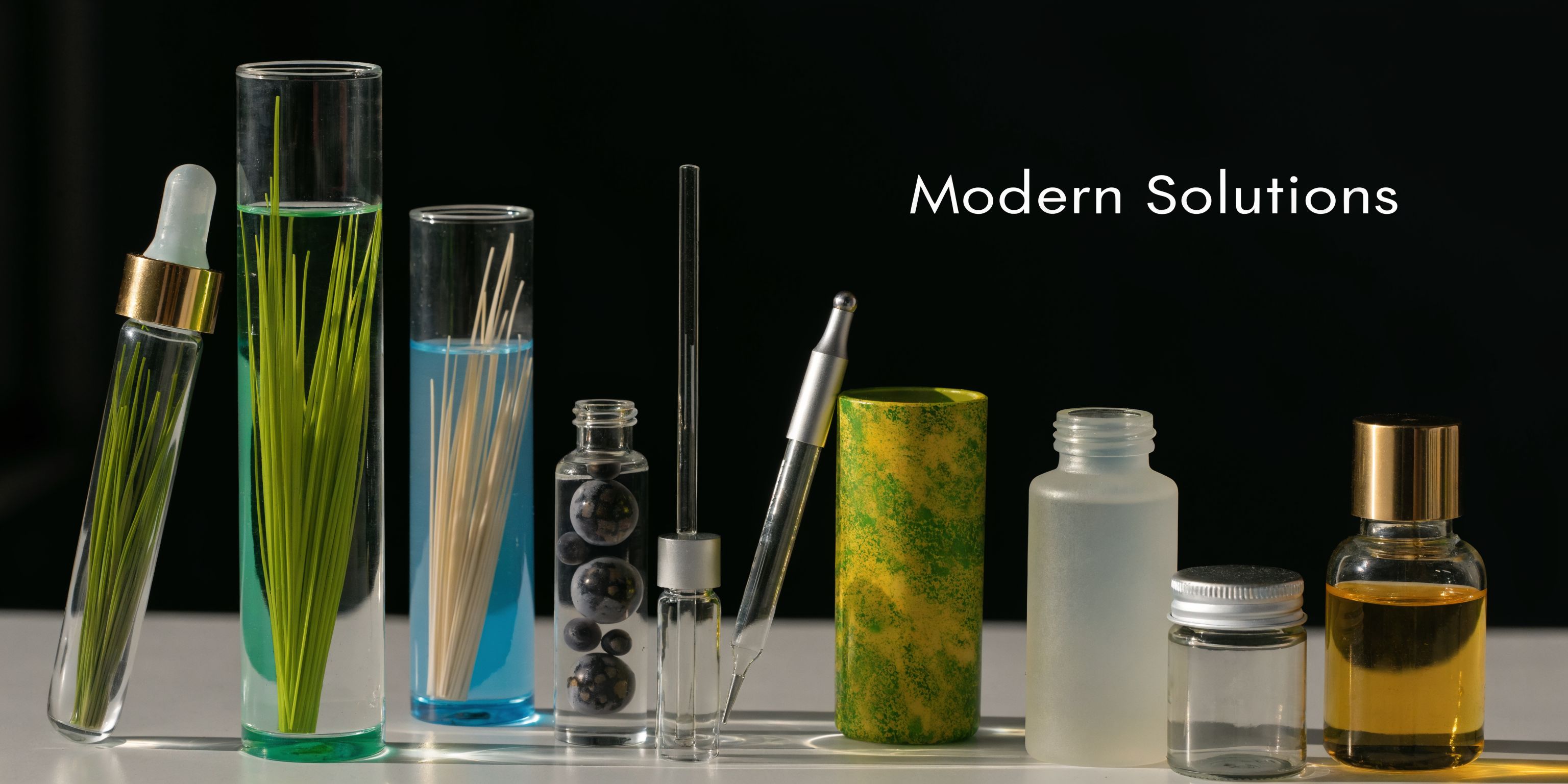 Various cosmetic ingredient samples and laboratory glass containers displayed against a simple black background for beauty research.
