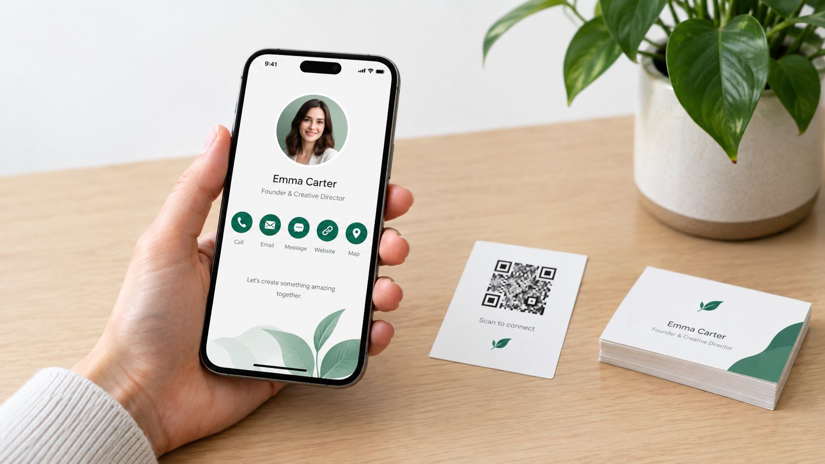 A hand holding a smartphone showing a digital business card with a QR code and contact details.