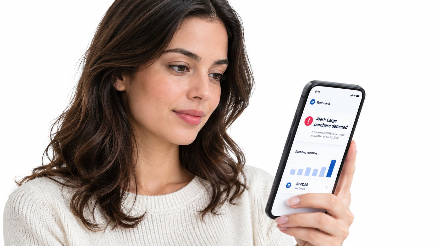 A young woman checks a bank notification about a large purchase on her smartphone screen.