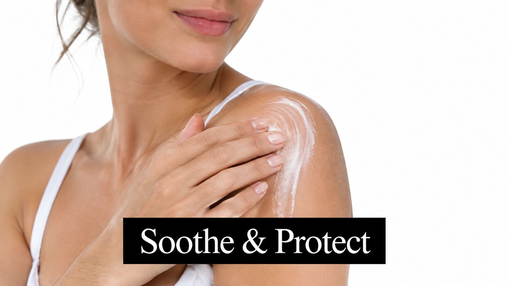 A woman applying a white moisturizing cream to her shoulder for soothing and protecting the skin.