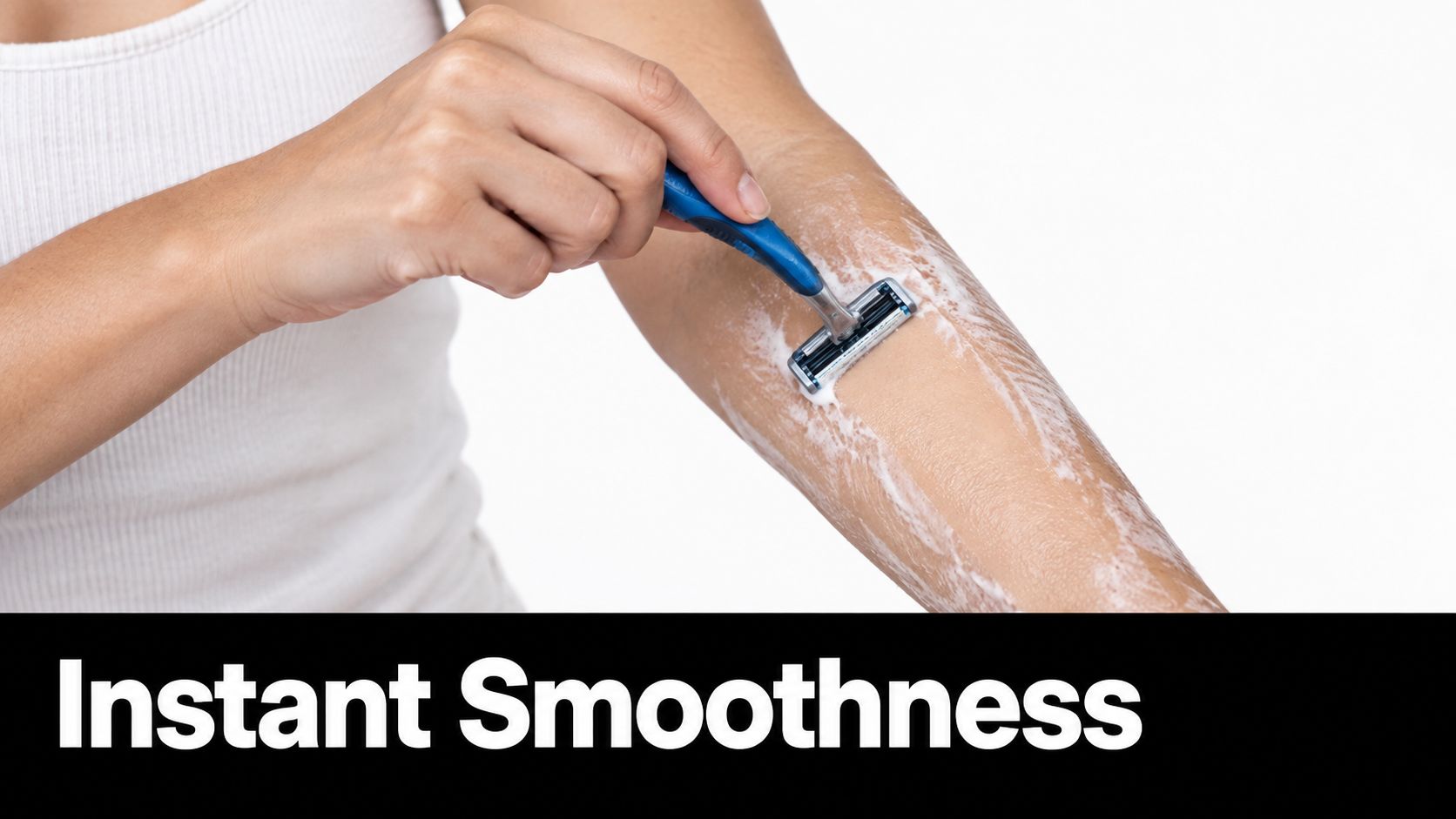 A woman shaving her arm with a manual razor while applying shaving cream for smooth skin.