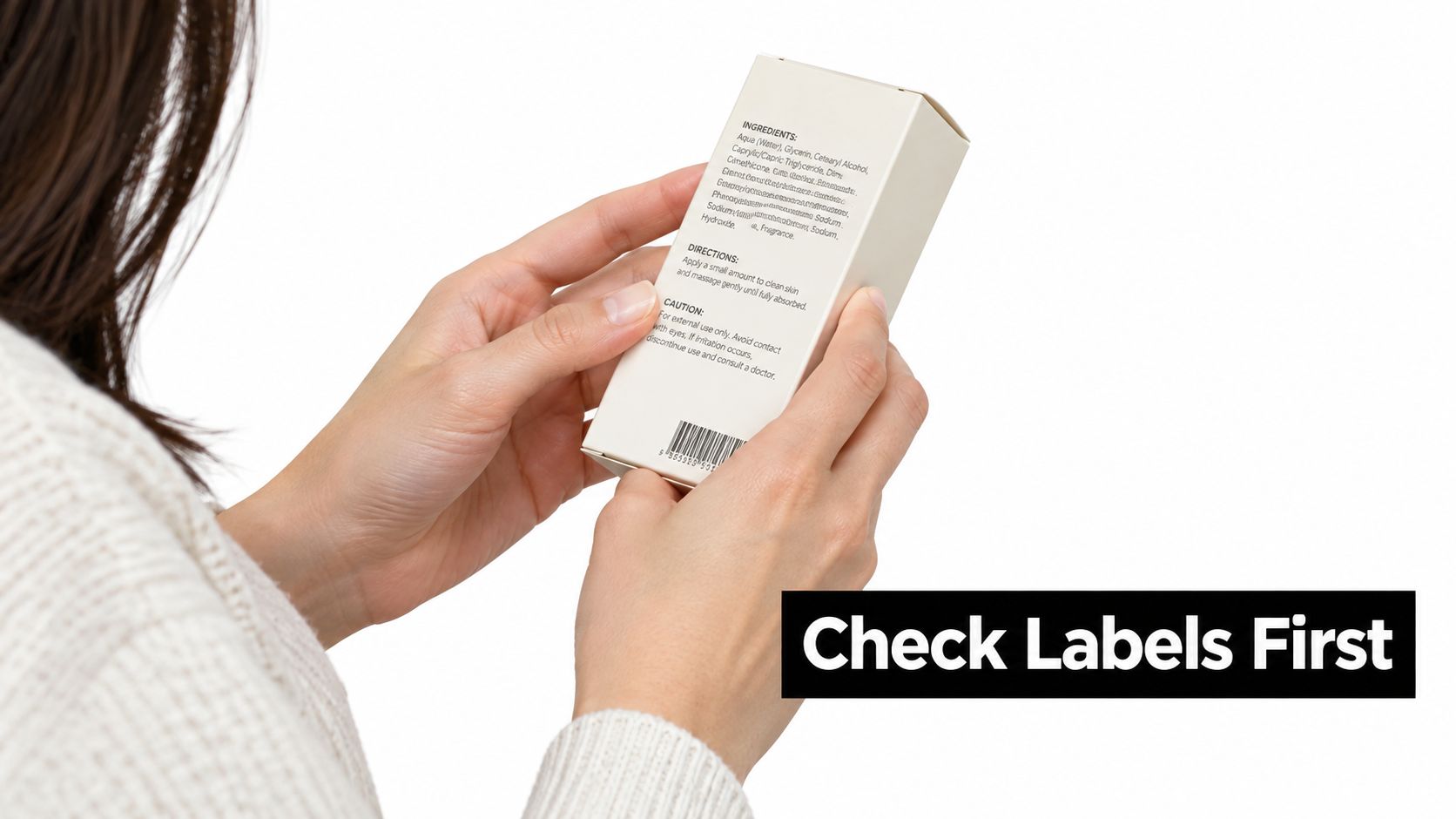 A woman reading the ingredients and directions on a product packaging box before applying it.