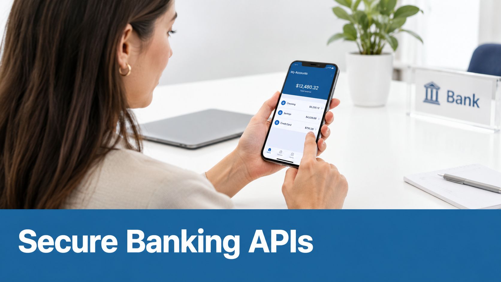 A woman holding a smartphone displaying her bank account balances with a secure banking interface.