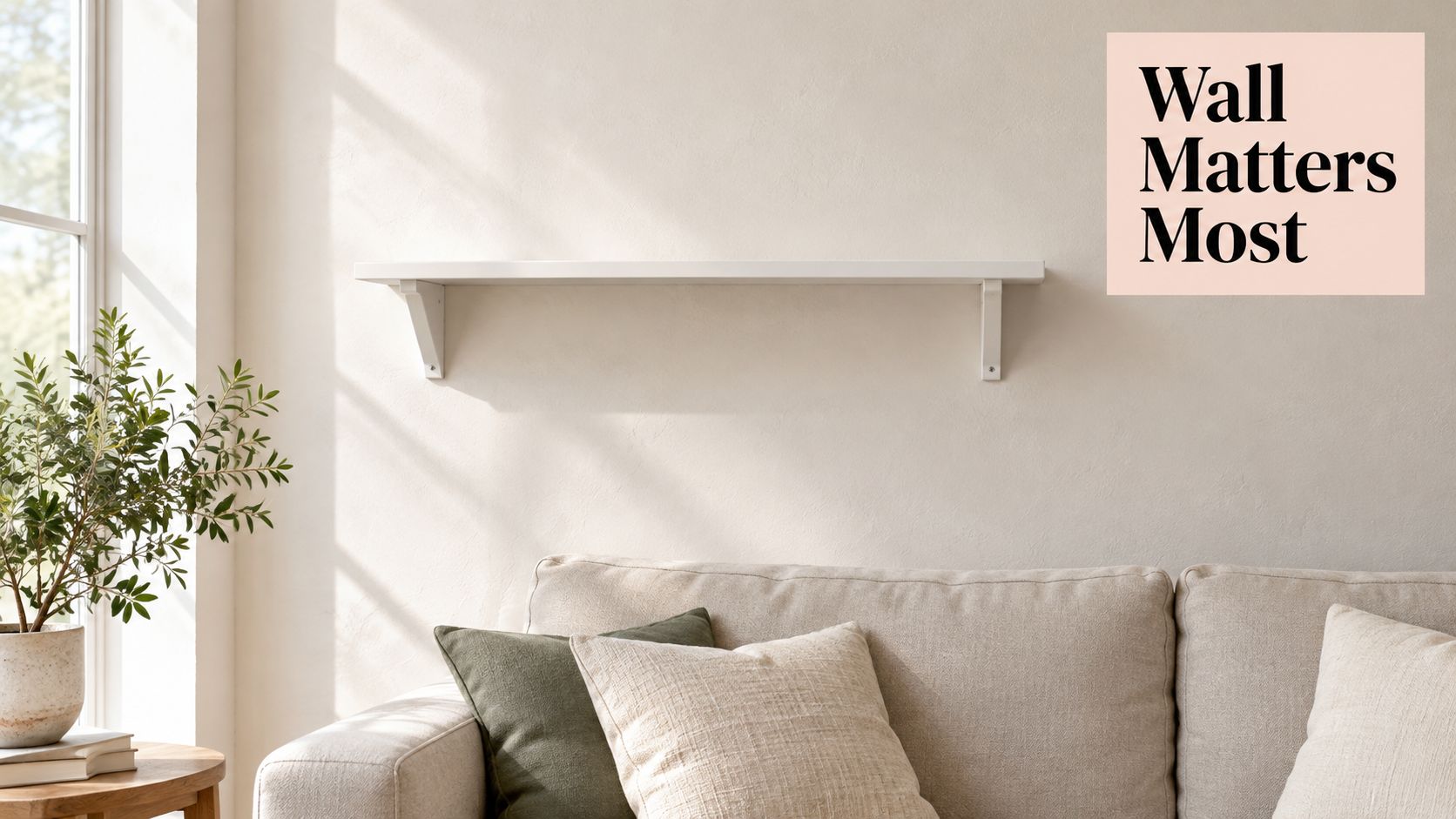 A modern living room featuring a simple white wooden floating shelf above a beige comfortable sofa.