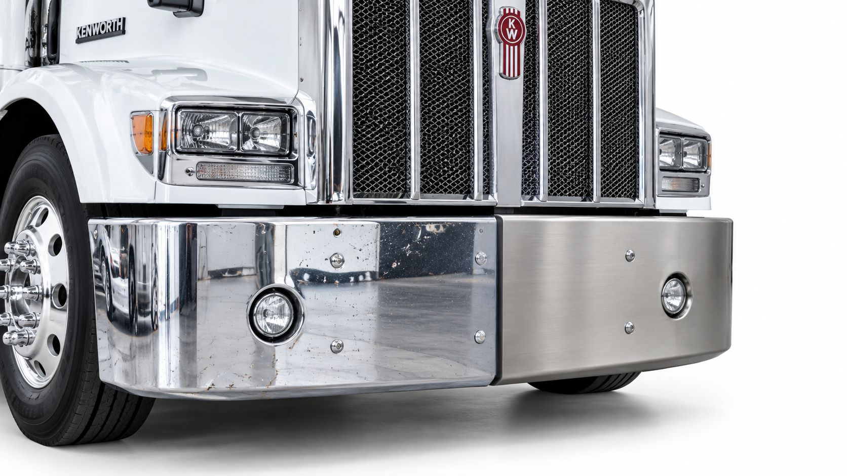 Close up front view of a Kenworth semi truck featuring a chrome bumper and the brand logo.