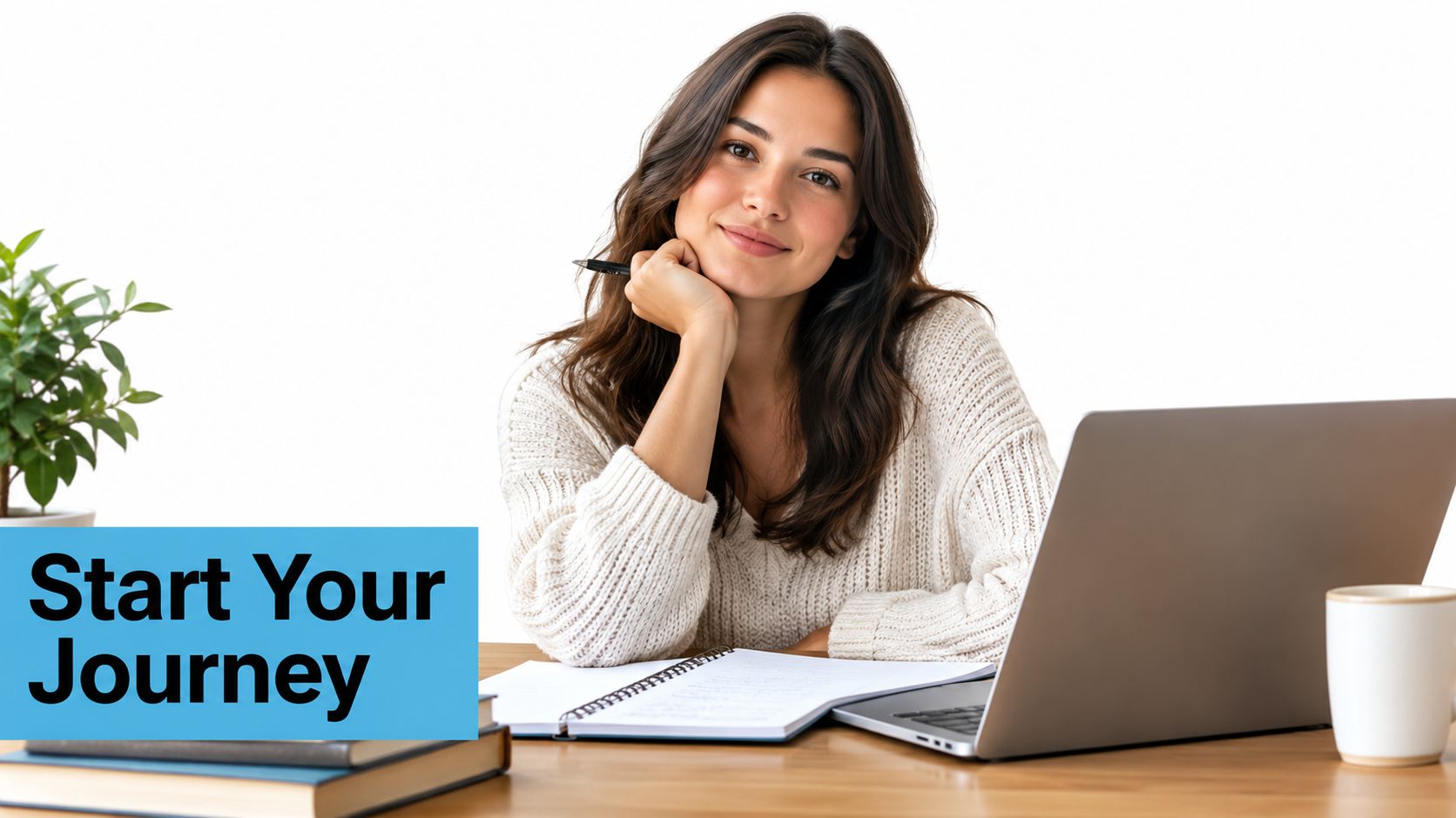 A smiling young woman sitting at a desk with a laptop, notebook, and a potted plant.