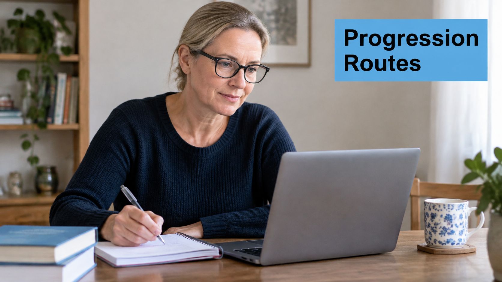 A middle-aged woman wearing glasses writing in a notebook while looking at a laptop computer at home.