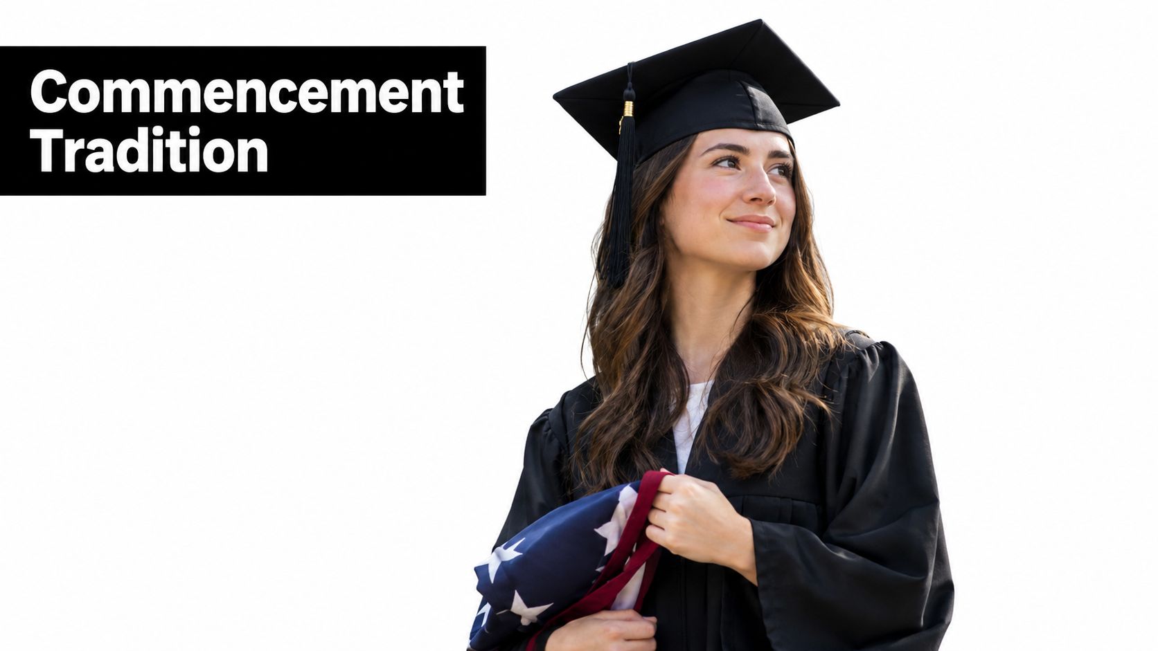 A female graduate in a cap and gown holding an American flag sash, looking away smiling.