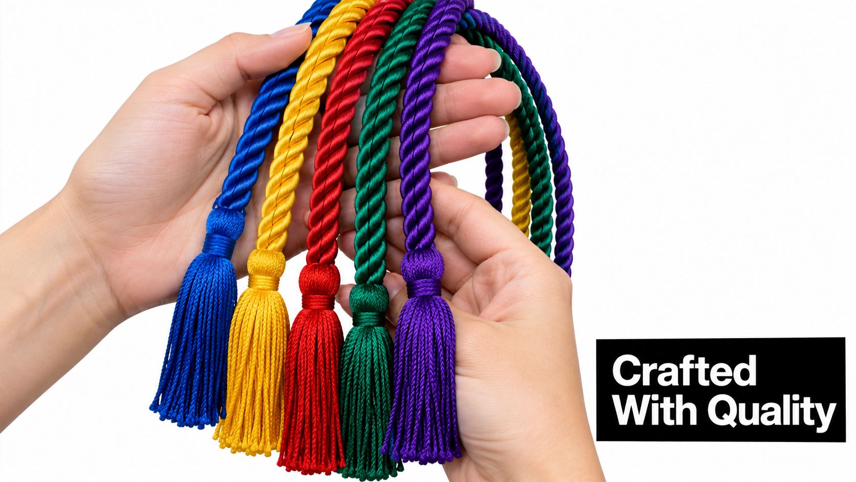 A person's hands holding five colorful braided graduation cords with tassels against a plain white background.