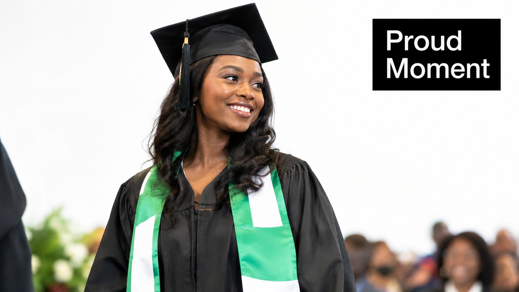A smiling young Black woman wearing a black graduation cap and a Nigerian flag graduation stole.