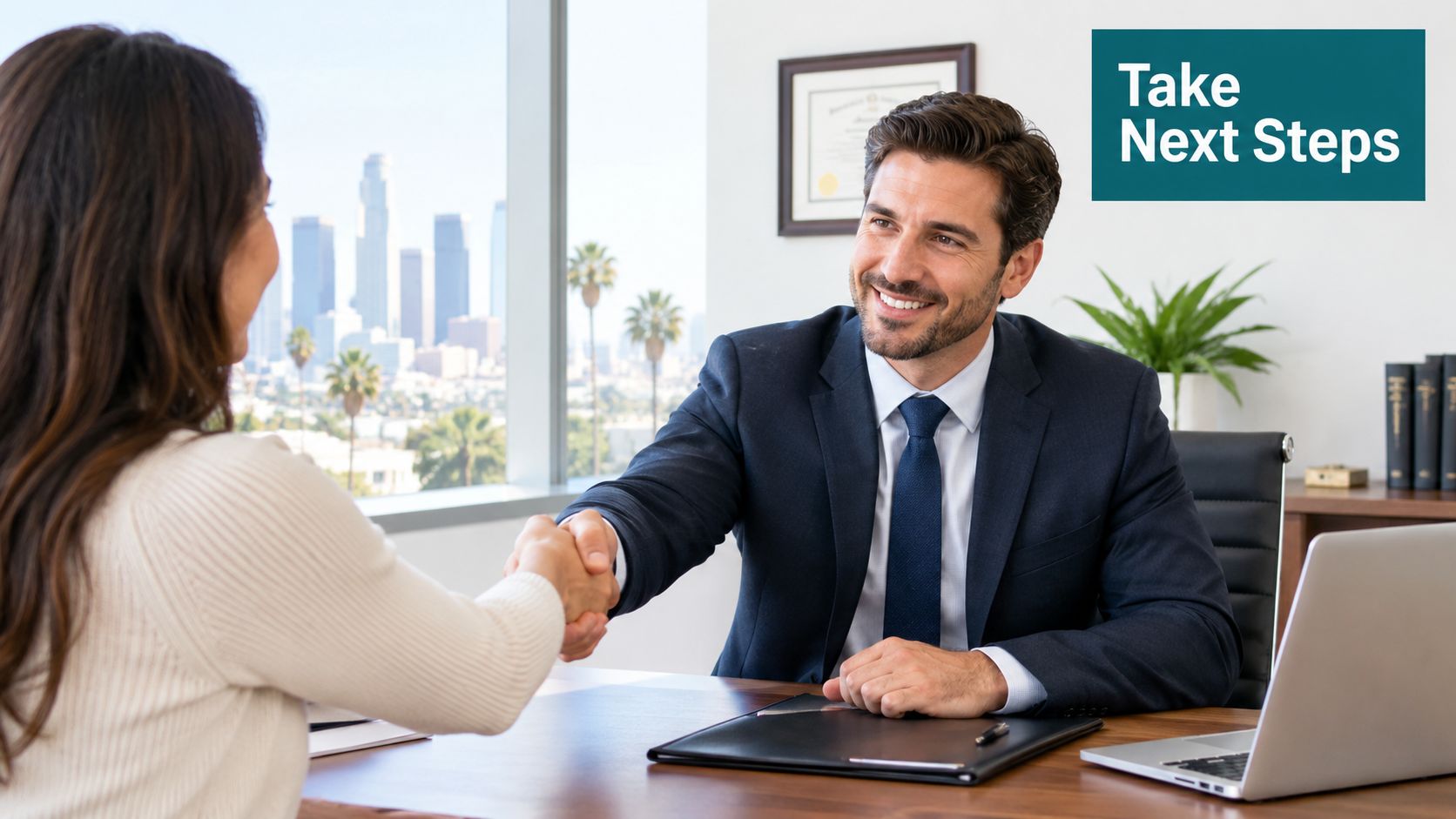 A professional man in a suit shaking hands with a client in a modern office with city views.