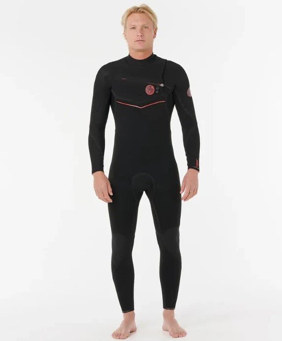 A man models a full-body black wetsuit with red stitching and logos, standing against a white background.