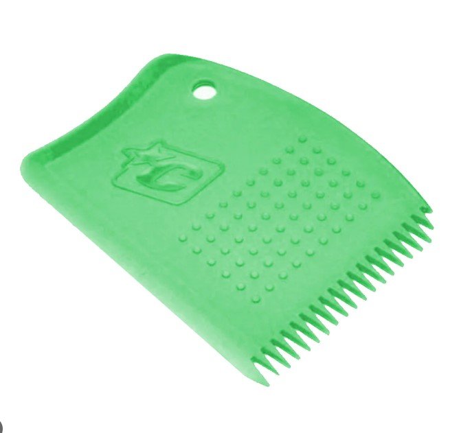 A green plastic surf wax comb with a serrated edge, textured grip dots, and a logo.