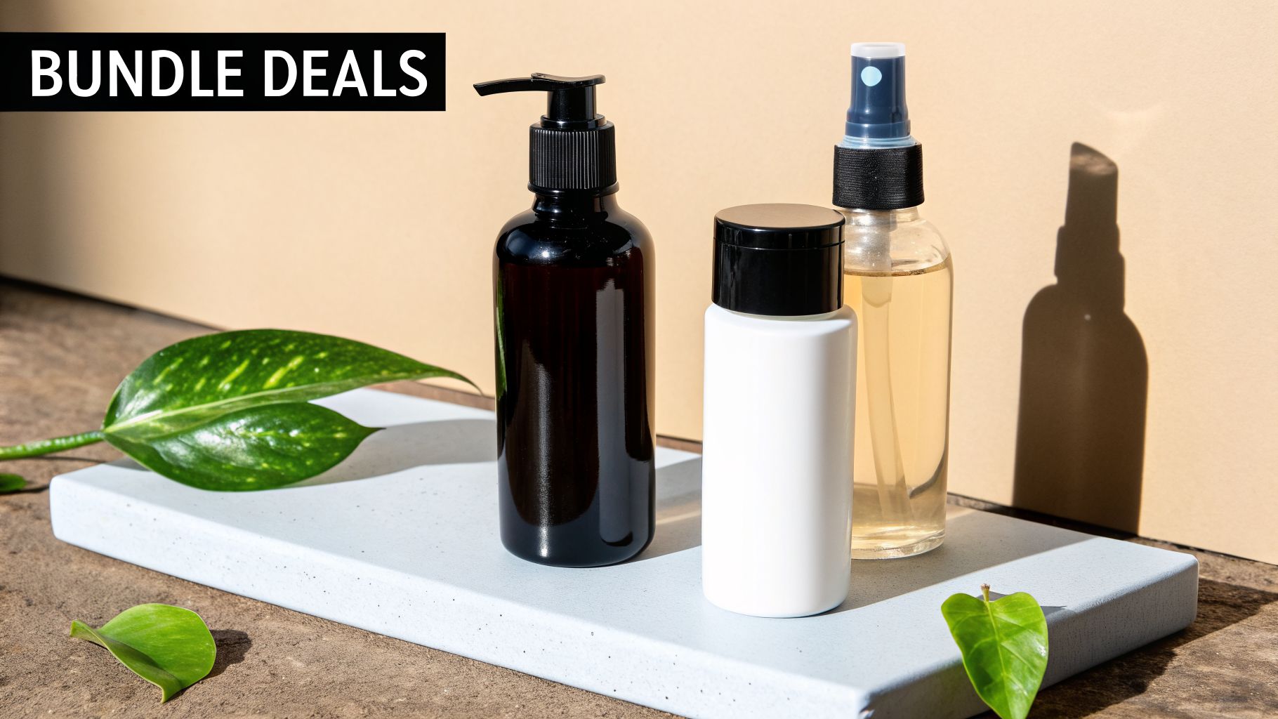 A bundle of dark and clear cosmetic bottles on a white display with green leaves, promoting bundle deals.