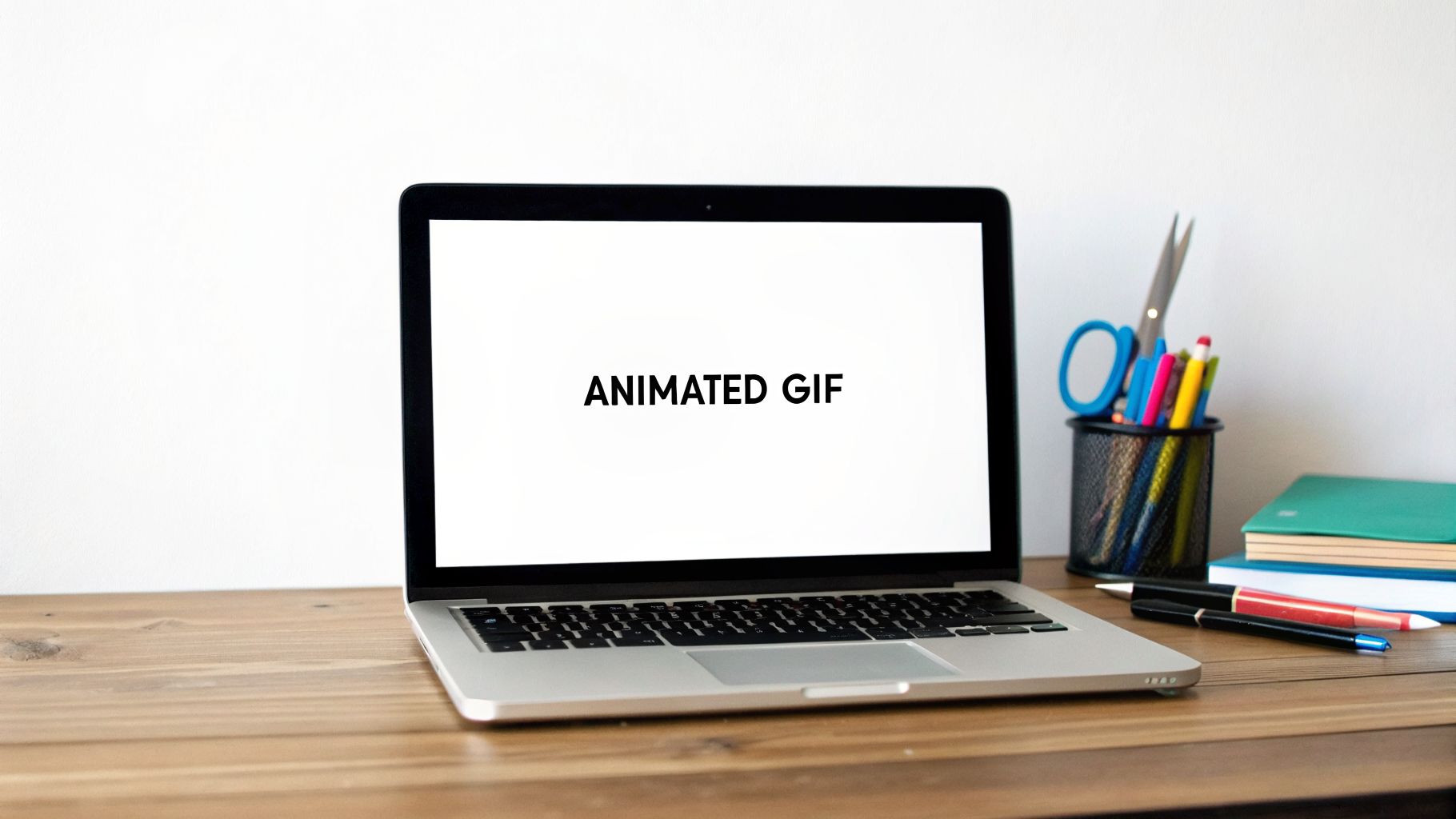 A laptop displays 'ANIMATED GIF' on a wooden desk with office supplies nearby.