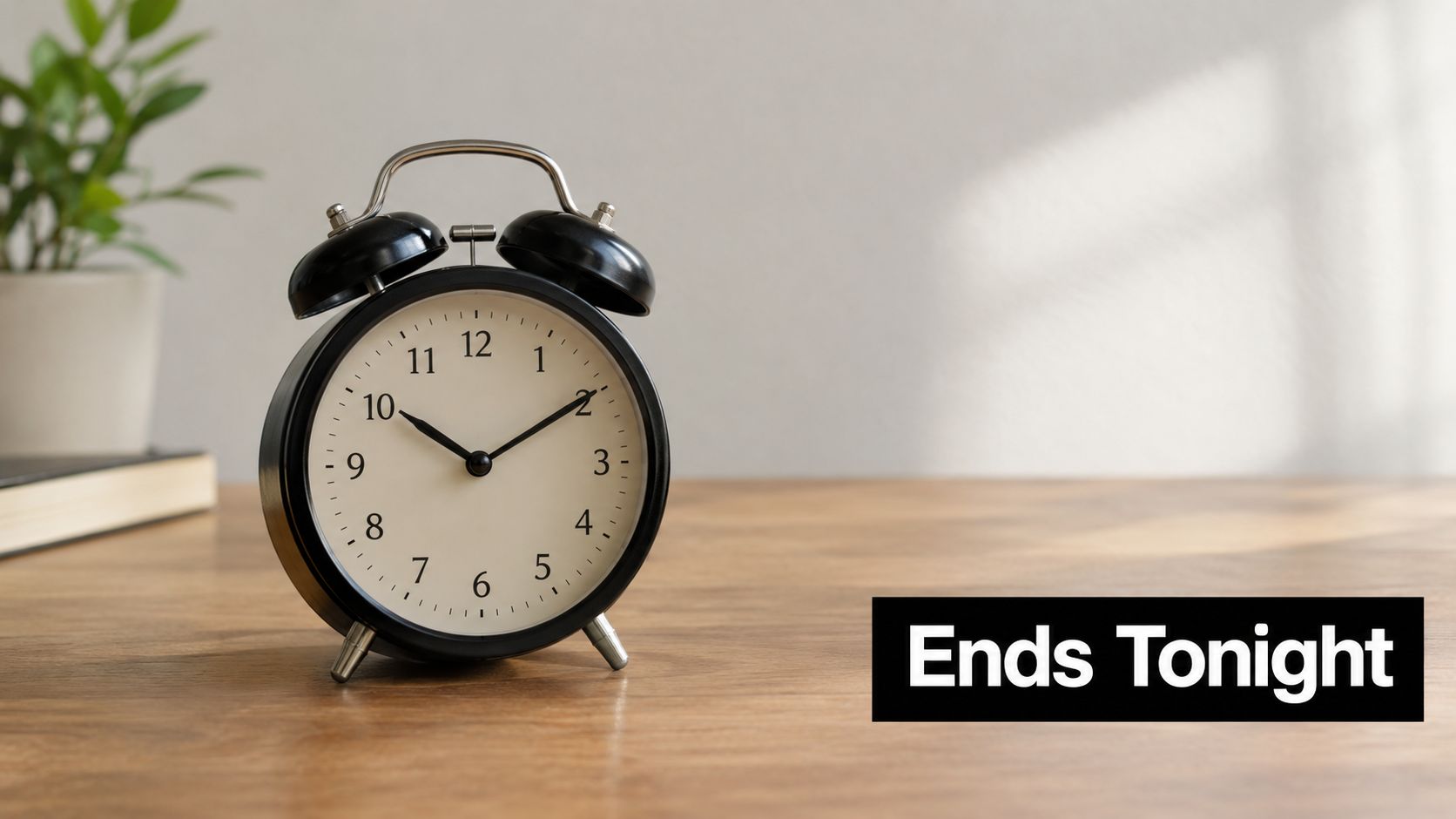An alarm clock on a wooden table with text saying Ends Tonight on the right side.