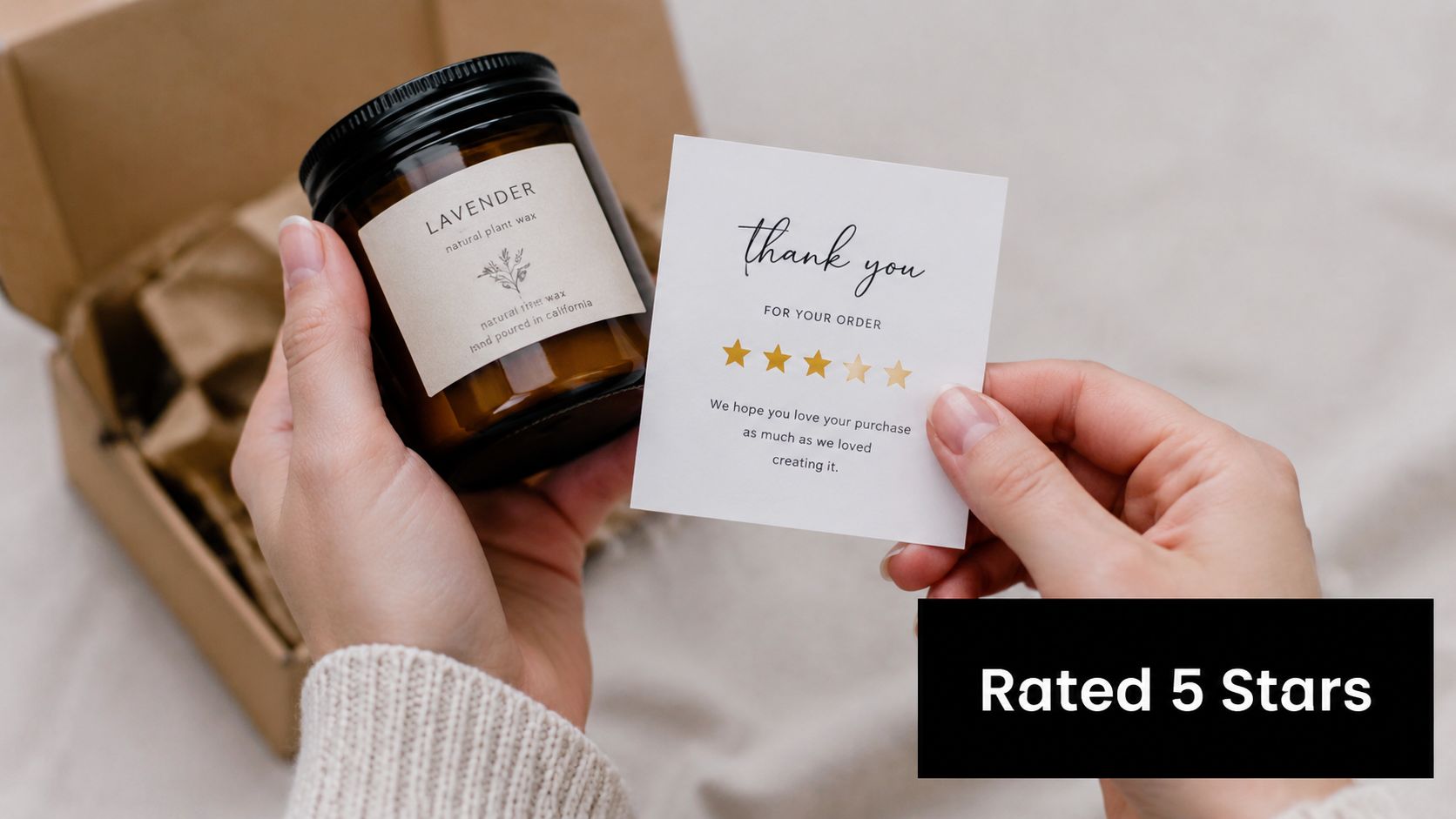 A person holding a jar candle and a thank you card featuring a five star rating system.