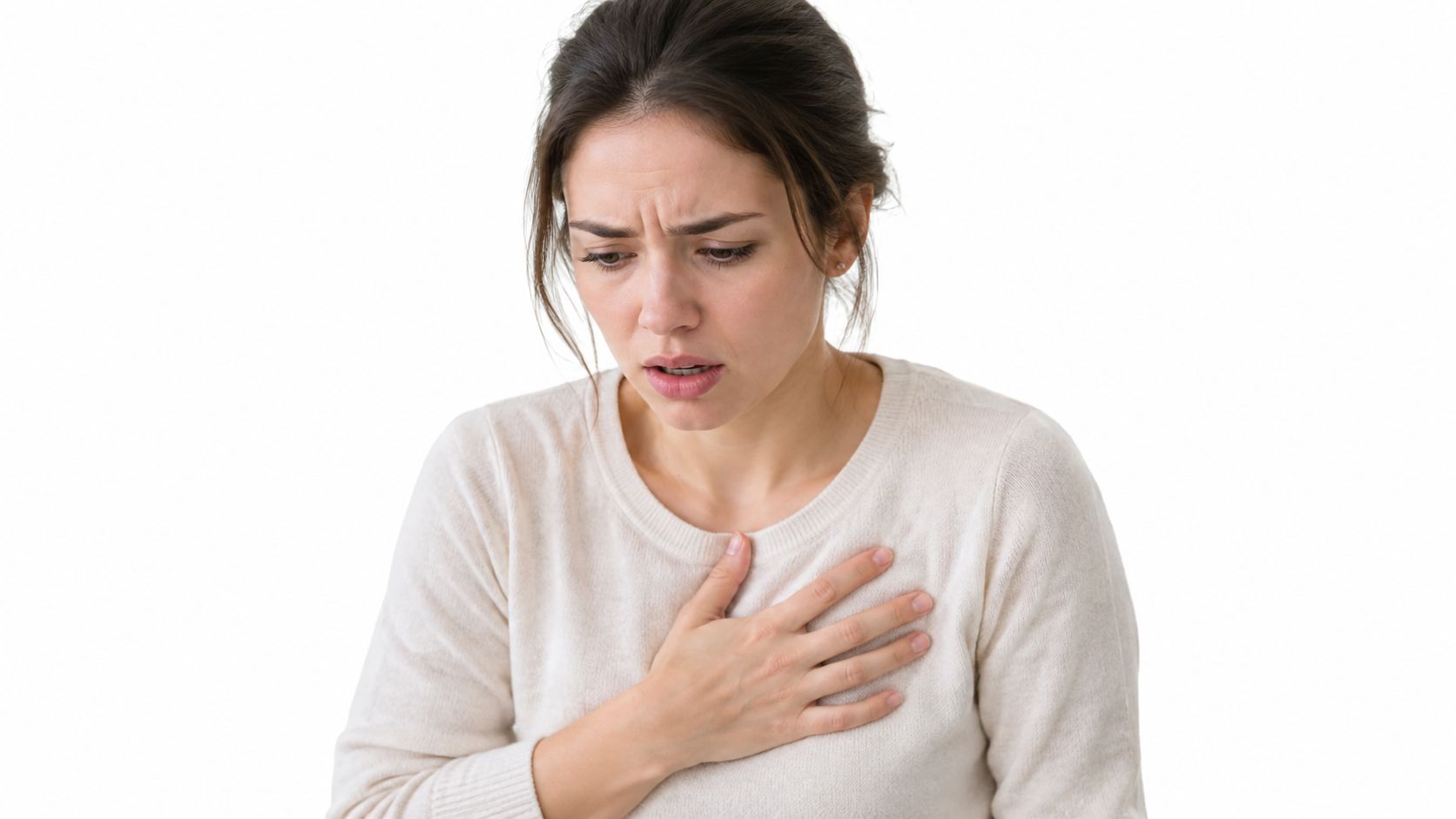A distressed woman holding her chest, illustrating symptoms of anxiety or physical discomfort in a medical context.