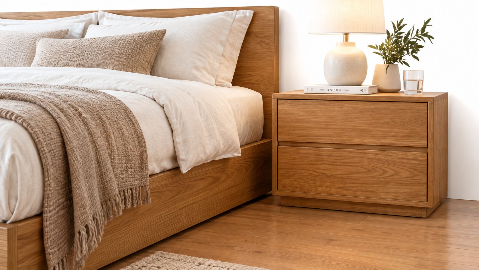 Mesita de noche de madera moderna junto a una cama con ropa de cama beige y elegante.