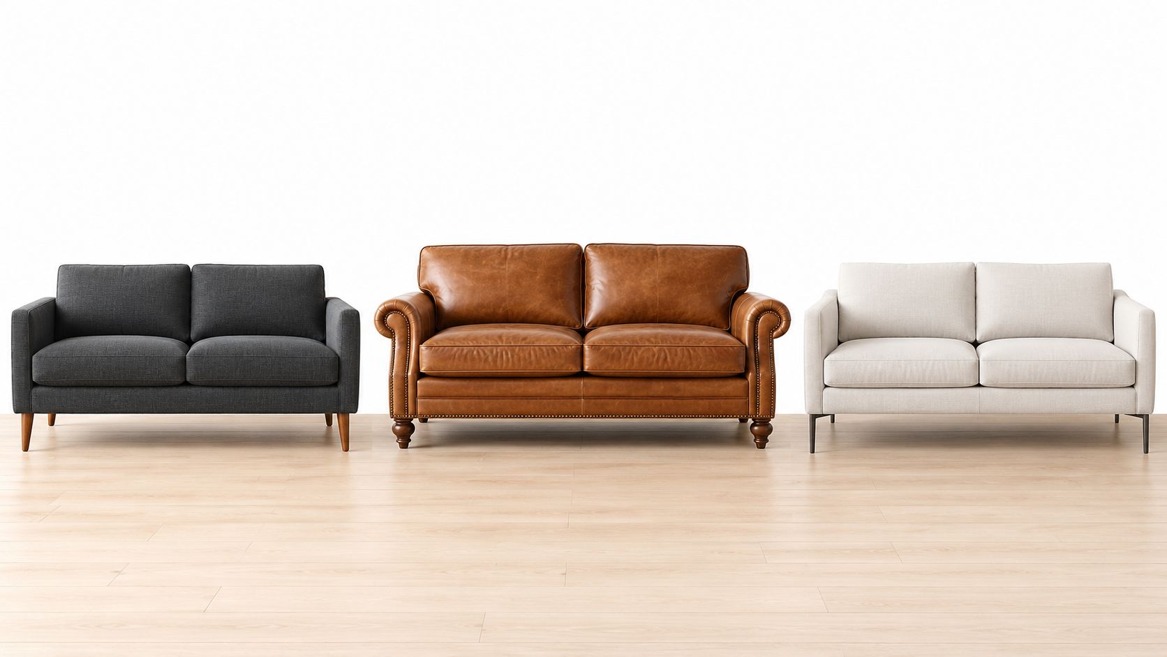 Tres sofás para dos personas con diferentes estilos, texturas y colores sobre un suelo de madera clara.