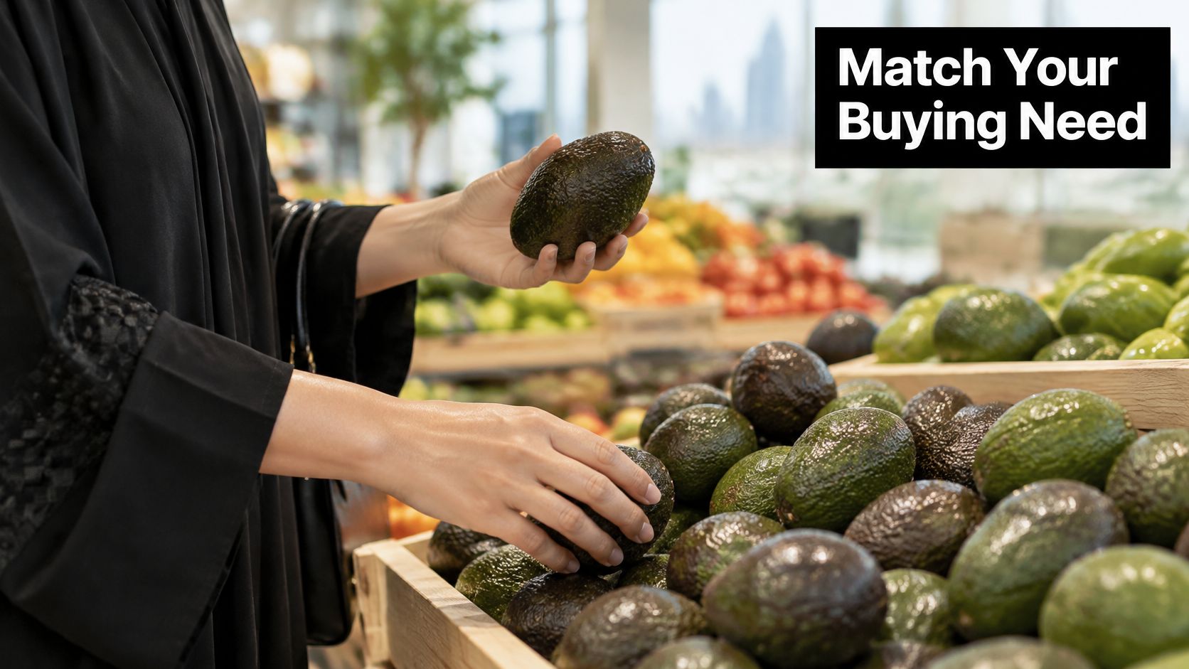 A woman in a black abaya selects a fresh avocado from a grocery store produce display.