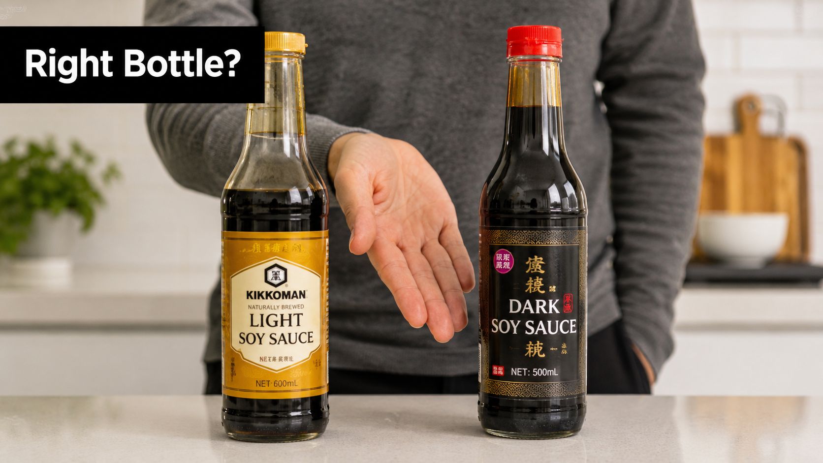 A person gesturing towards two bottles of soy sauce, one light and one dark, on a kitchen counter.
