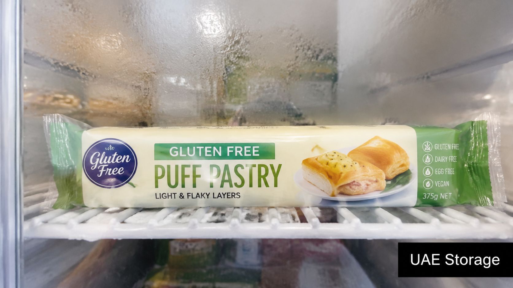 A package of gluten-free puff pastry stored on a shelf inside a cold freezer unit.