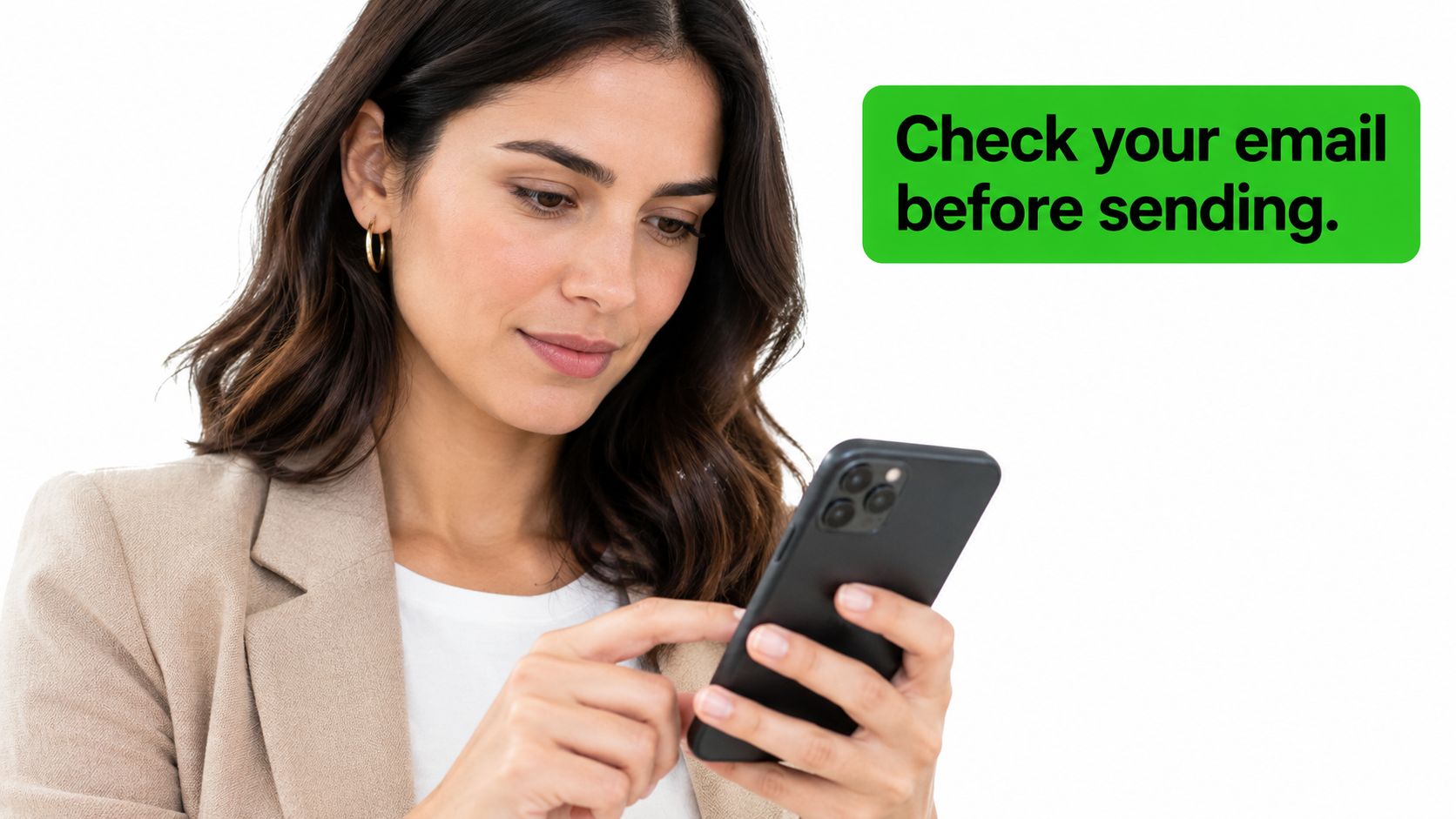 A professional woman checking her email on a smartphone with a green notification box nearby.