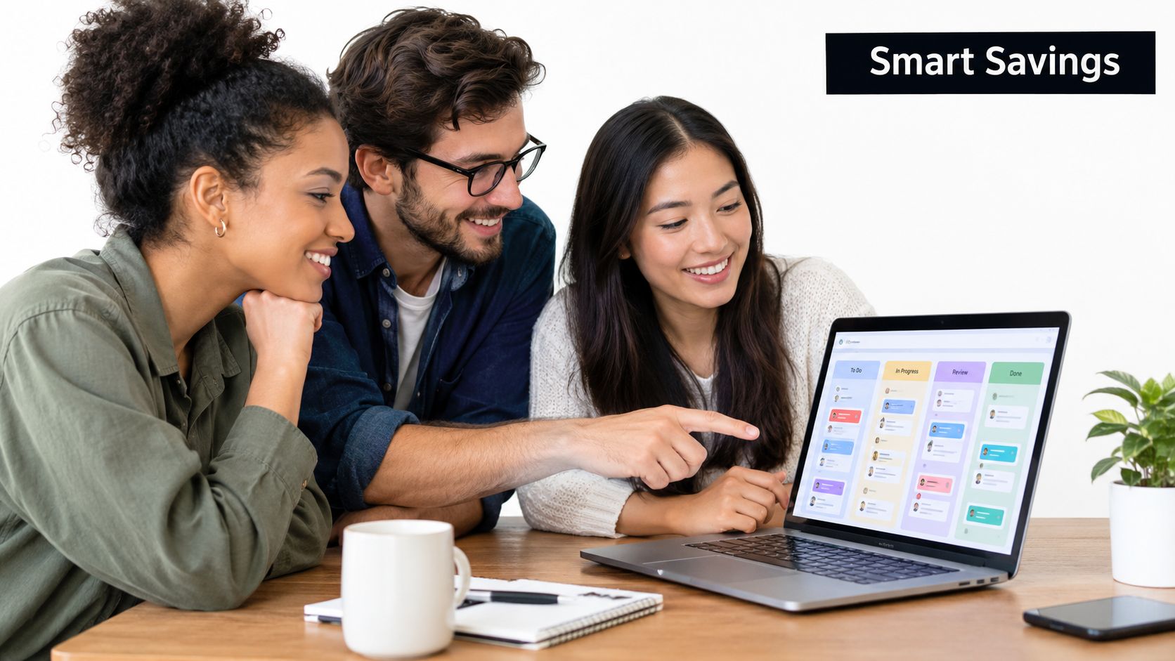 A diverse group of three professionals collaborating on a project using project management software on a laptop.