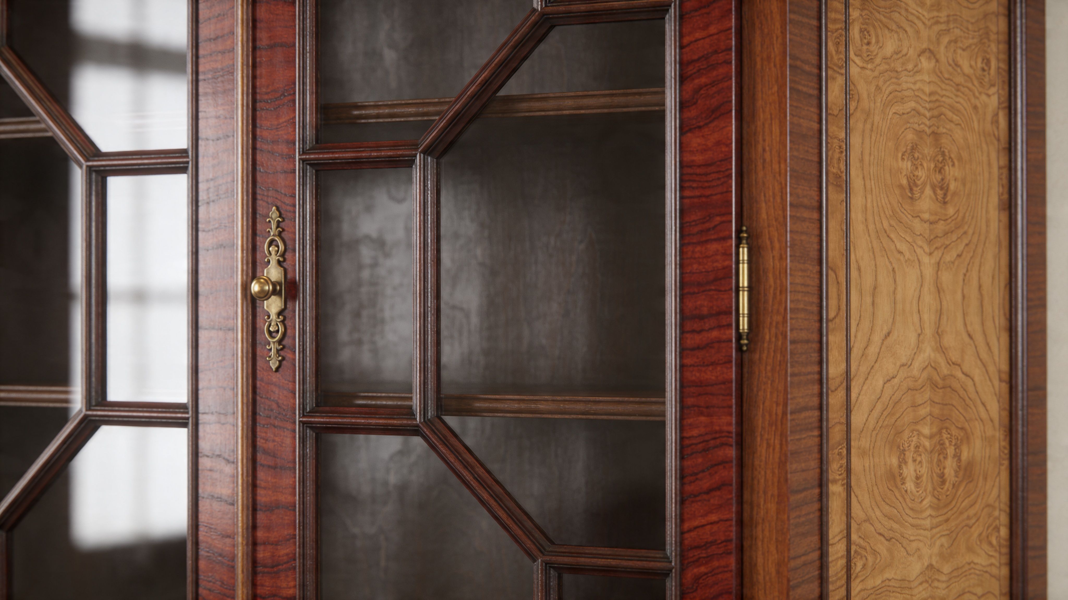 A close-up view of a high-quality wooden display cabinet featuring ornate brass hardware and intricate glass paneling.
