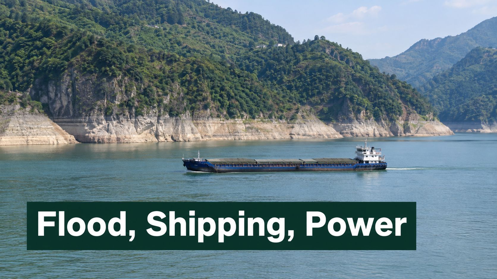 A cargo ship travels along the Yangtze River past the mountainous landscape near the Three Gorges Dam.
