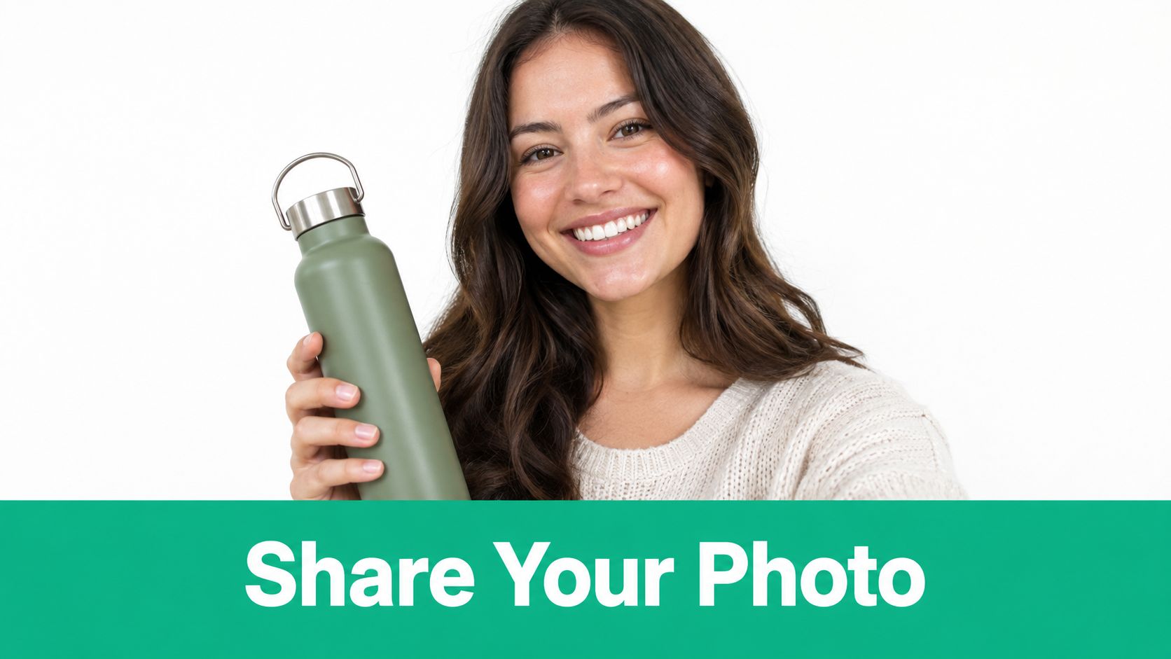A smiling young woman holding a green reusable water bottle in front of a white background.