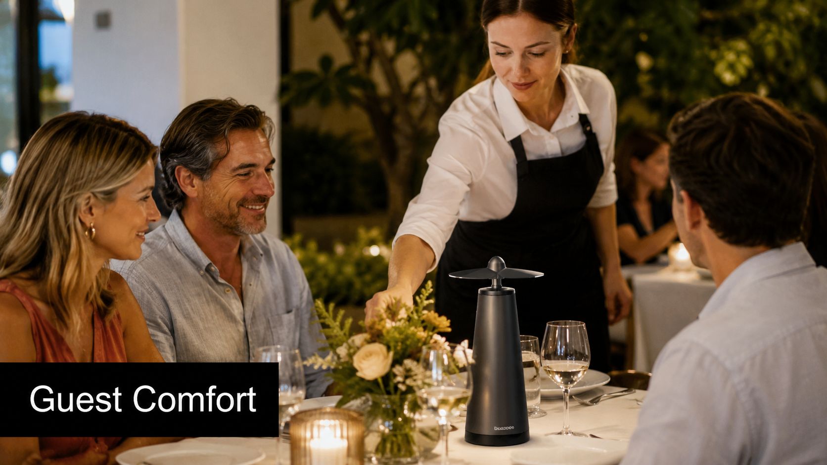 A waitress serving a table of happy diners in an upscale restaurant with a fly fan centerpiece.