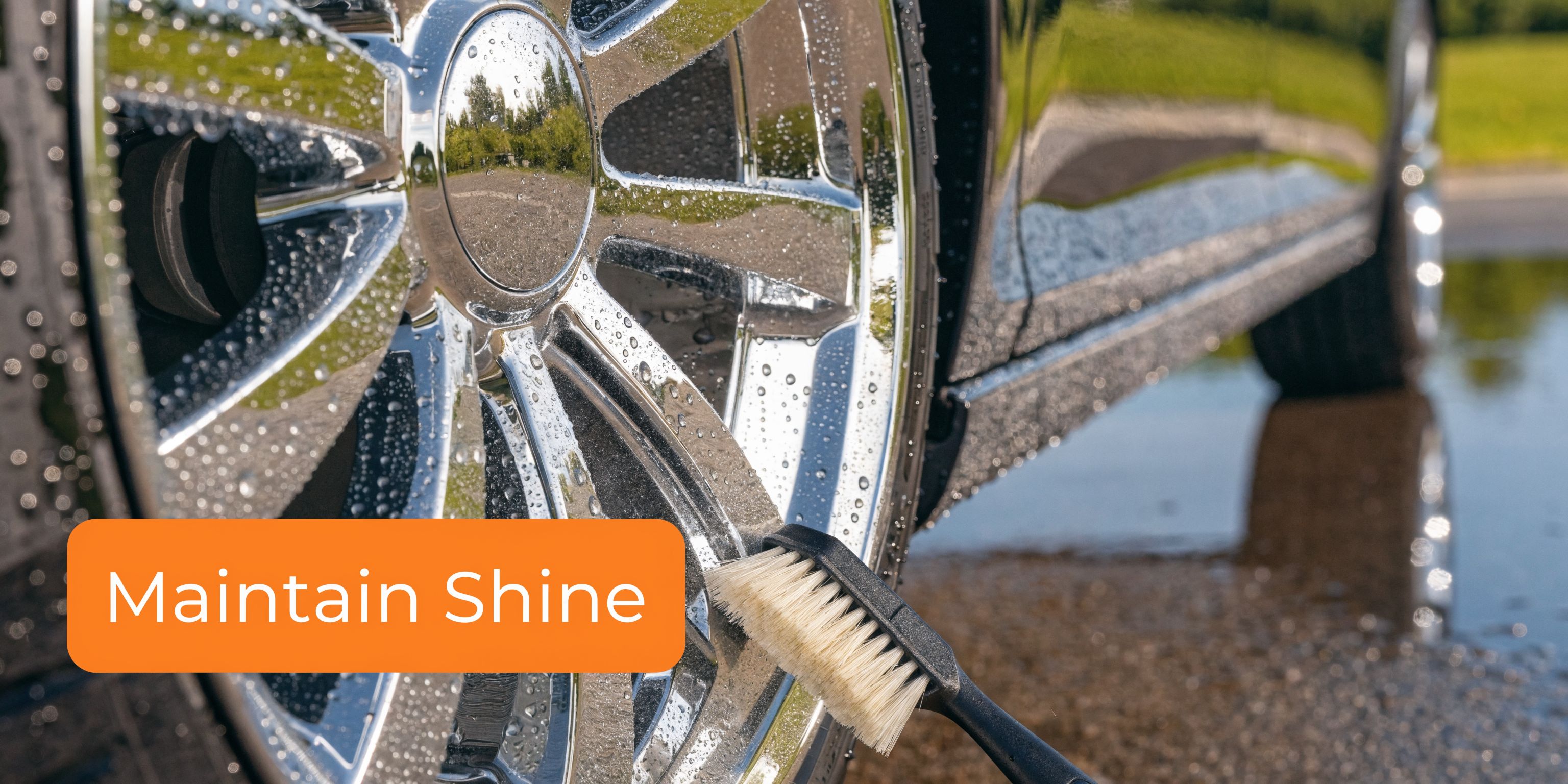 A close-up view of a car wheel being cleaned with a brush to maintain its shine.