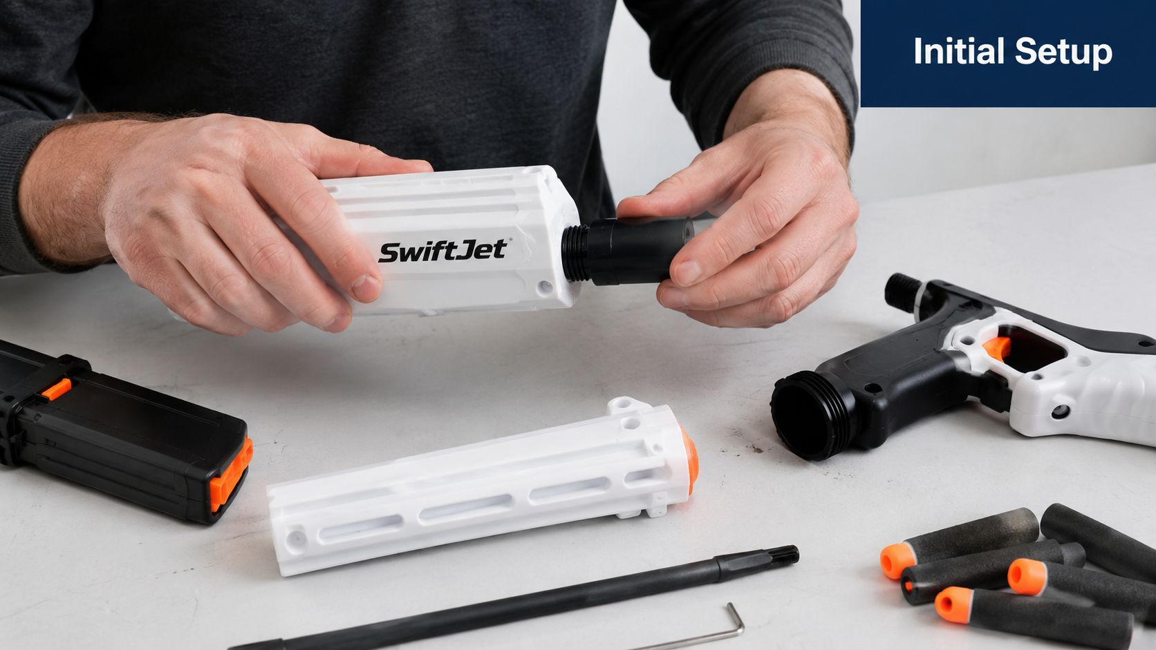 A pair of hands assembling a toy blaster with various components laid out on a white surface.