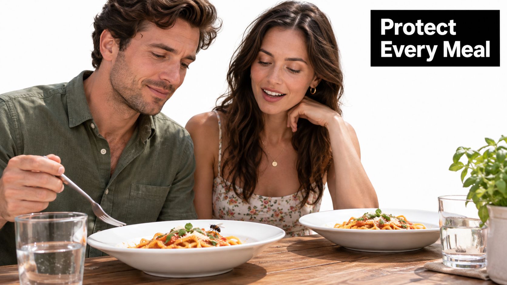 A couple dining outdoors with pasta while a fly lands on the man's dish, emphasizing food hygiene.