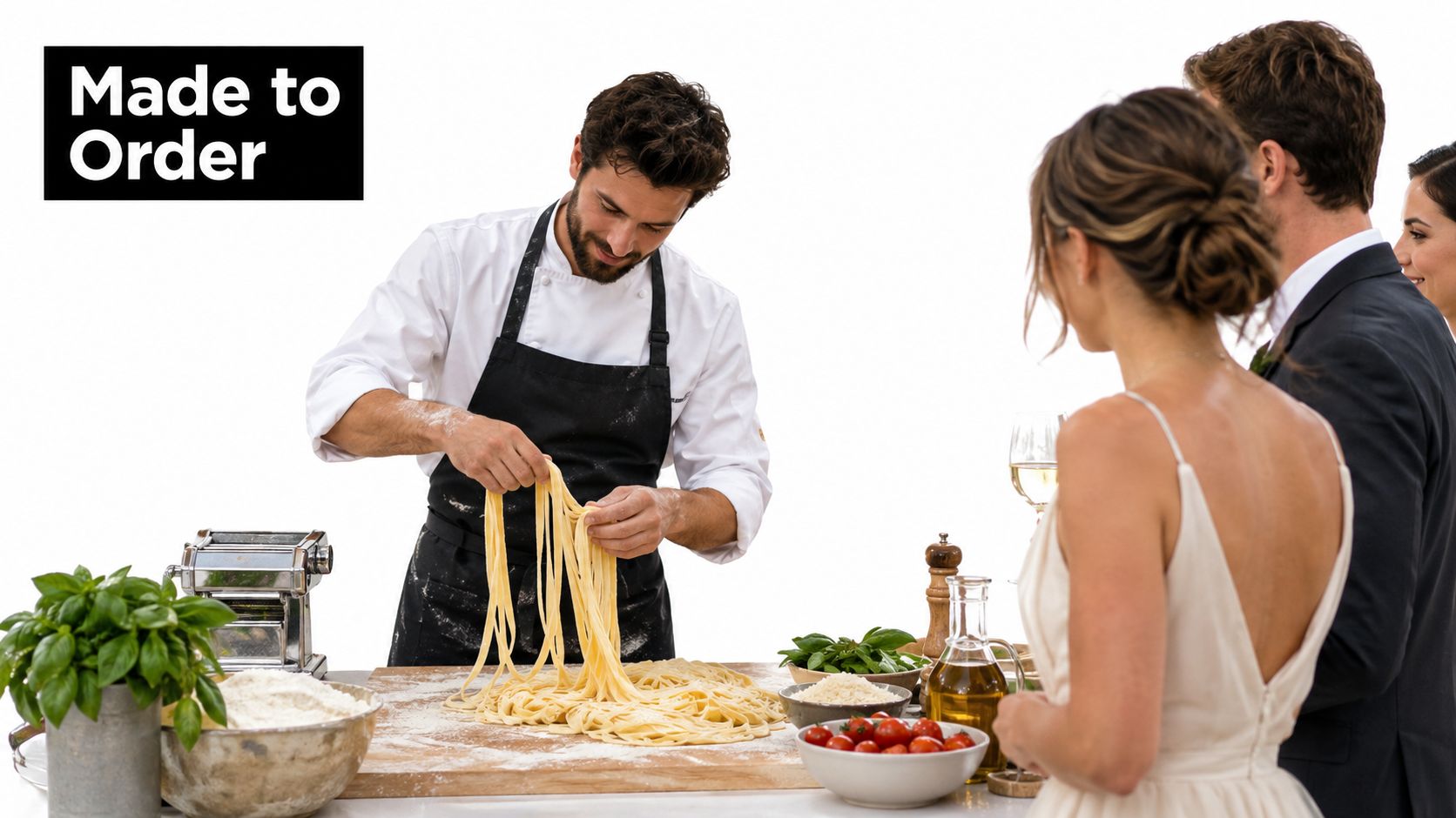 A professional chef preparing fresh pasta for a couple at a wedding event catering station.