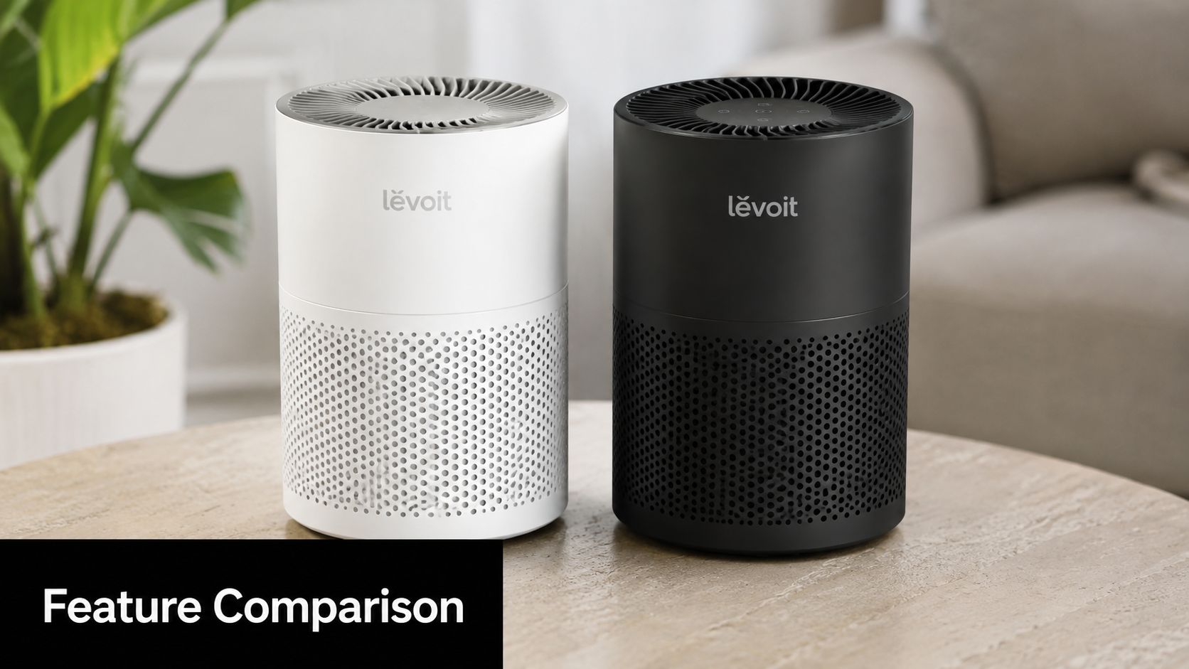 A white and black Levoit air purifier standing side by side on a wooden table.