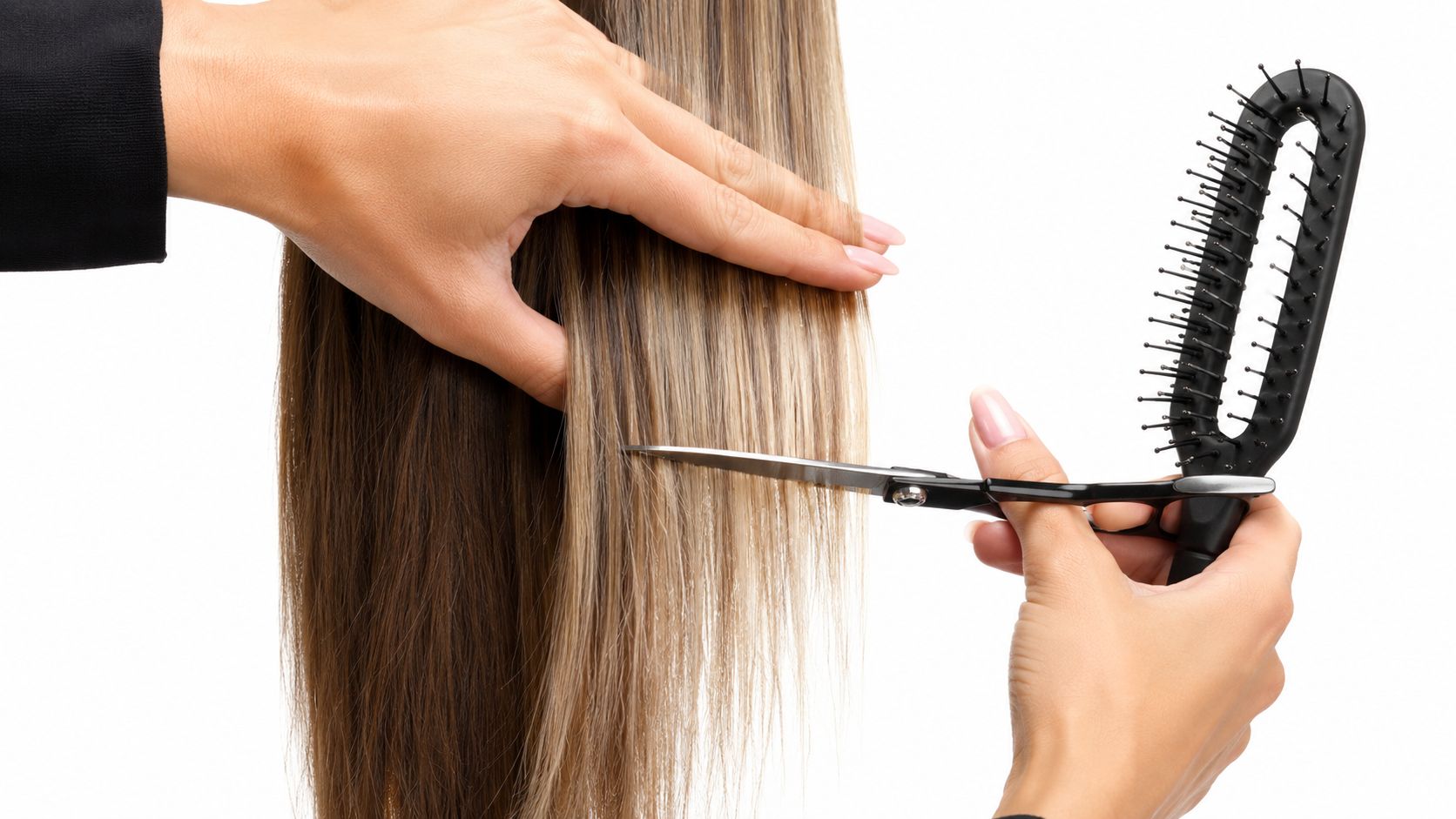 A professional hairstylist trimming long, straight, highlighted hair while holding a comb in the same hand.