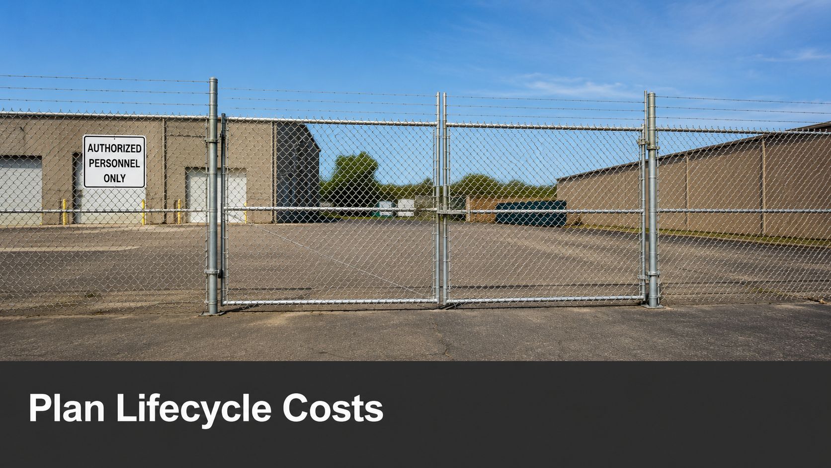 A wide view of a secure facility with commercial chain link fencing and an authorized personnel sign.