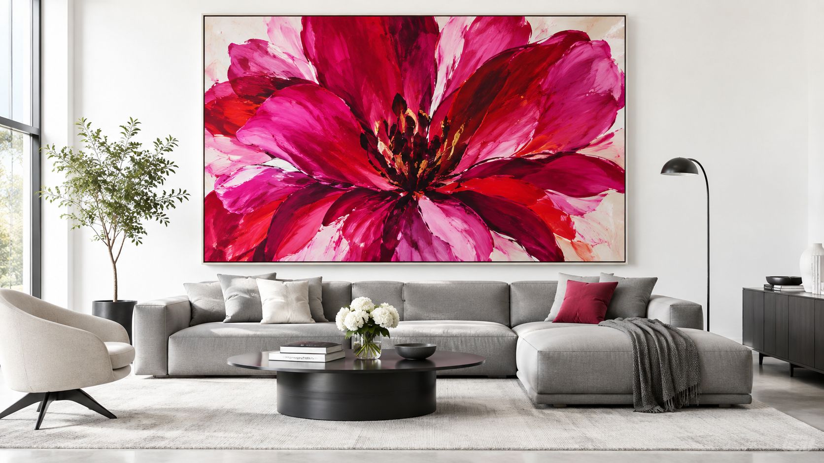 A modern living room featuring a large, vibrant pink flower painting hanging above a contemporary gray sectional sofa.
